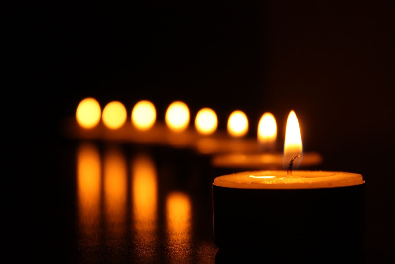 Candles burning in a dark room